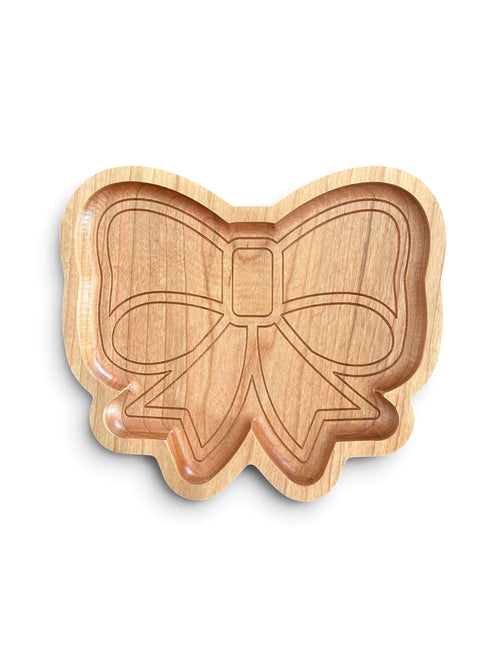 A light natural wood bow-shaped tray with an engraved bow design, shown on a clean white background.
