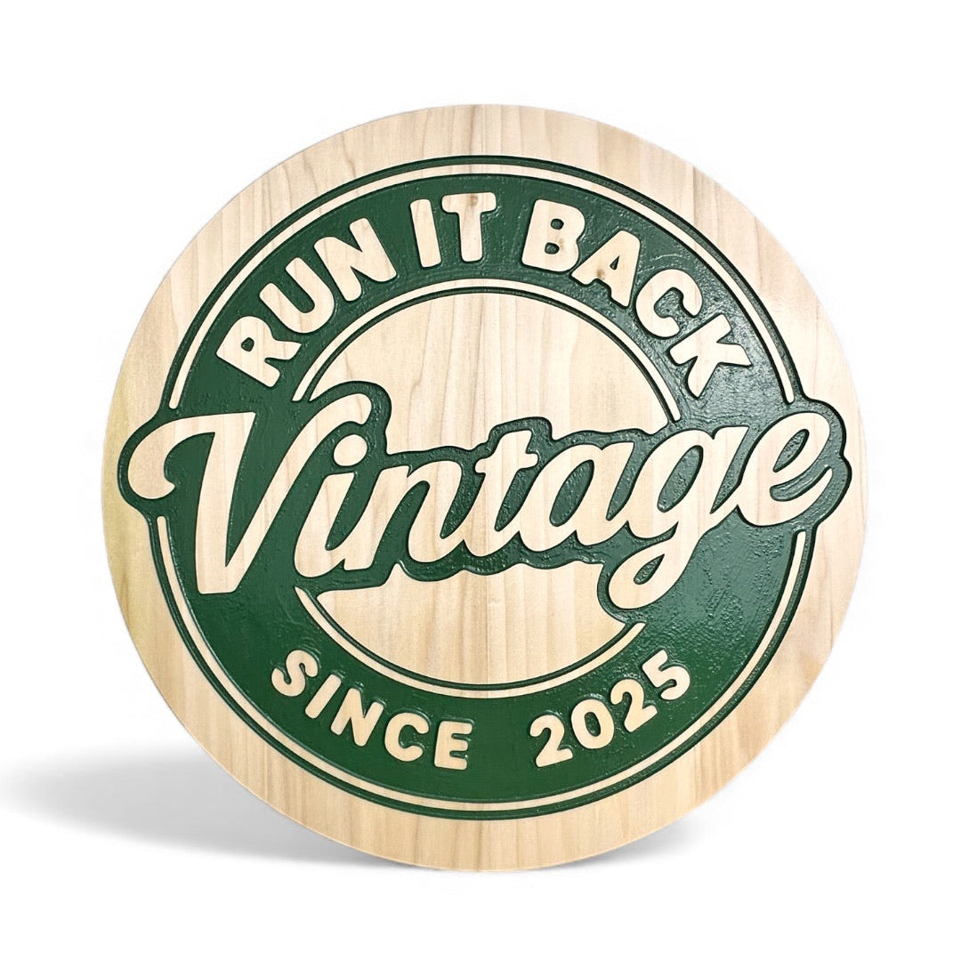 A round wooden plaque on poplar and a dark green engraved graphic in the center. The graphic features the words 'RUN IT BACK', 'Vintage', and 'SINCE 2025'.