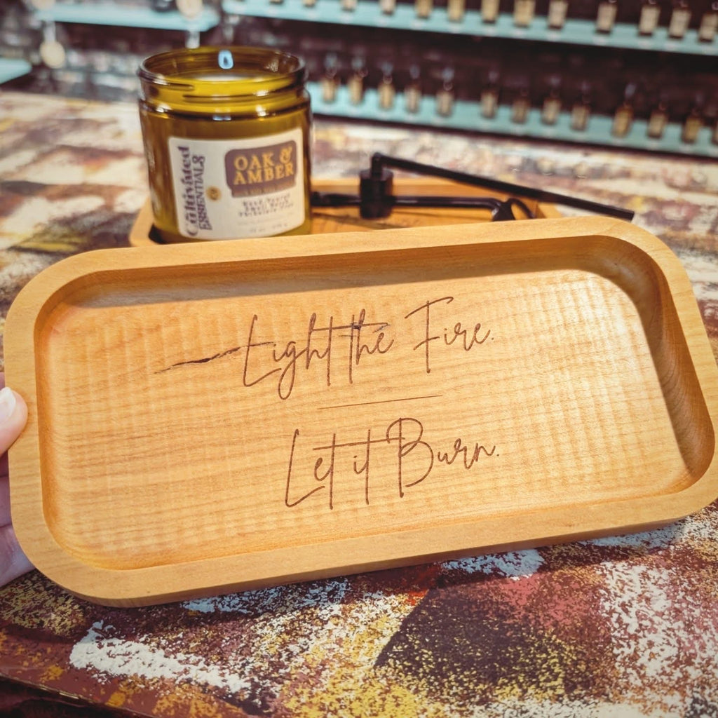 A rectangular light wood smoking tray engraved with the words 'Light the Fire. Let it Burn.