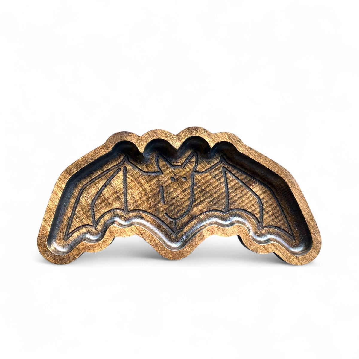 A wooden tray shaped like a bat, featuring a natural wood grain finish with darkened recessed details, shown on a plain white background.