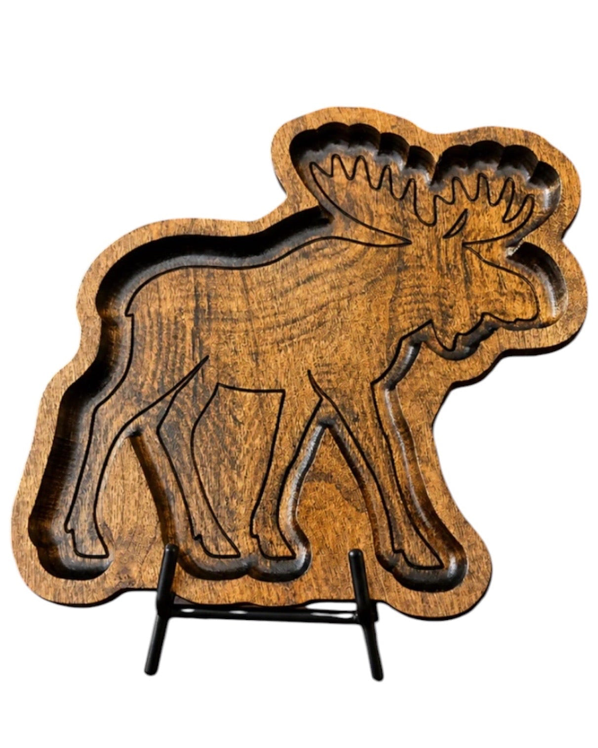 A carved wooden moose-shaped tray or serving board with a natural wood grain finish, displayed on a small black metal stand against a plain white background.