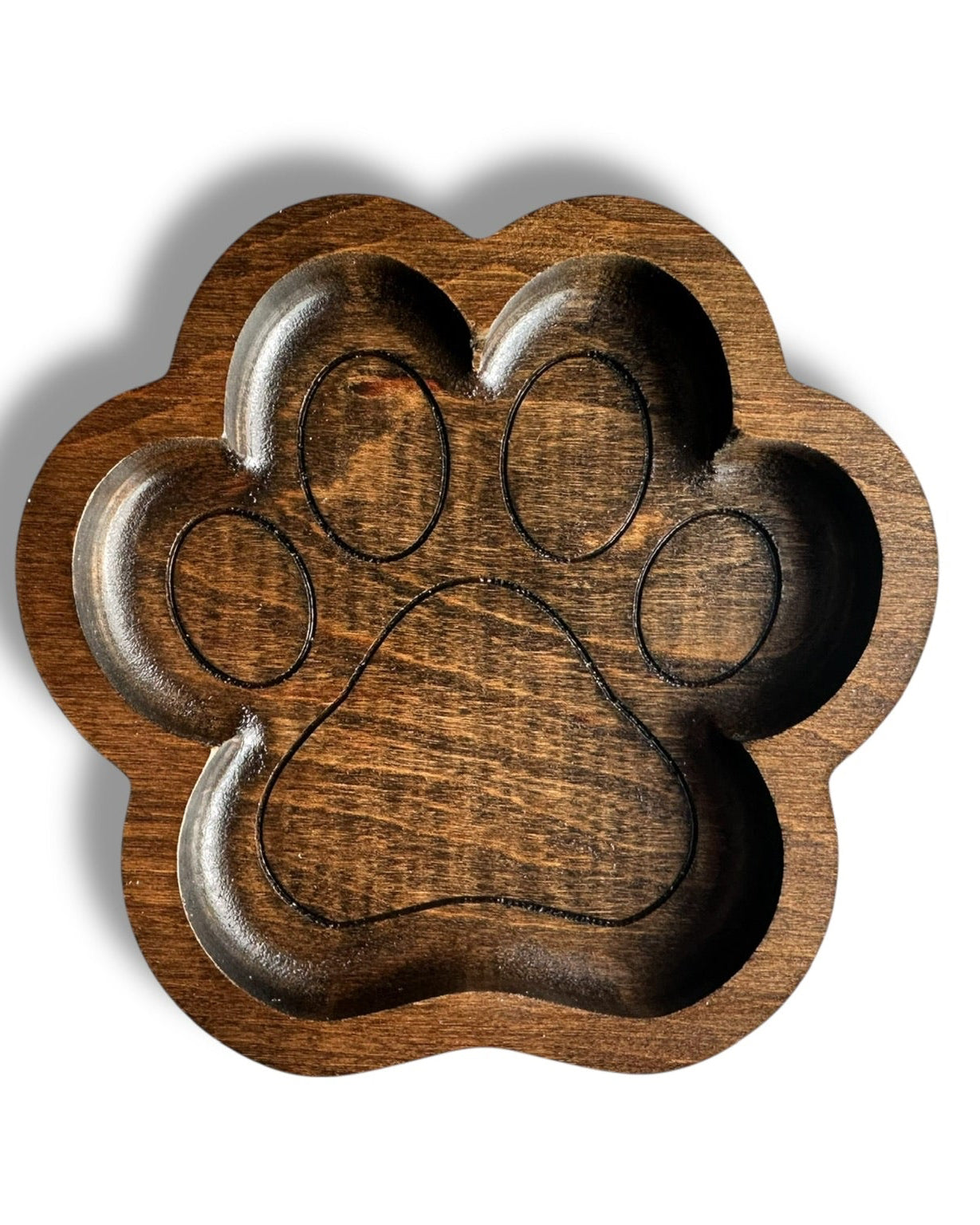 A paw print shaped wooden bowl with a dark brown wood grain finish, shown from a top-down view on a white background.